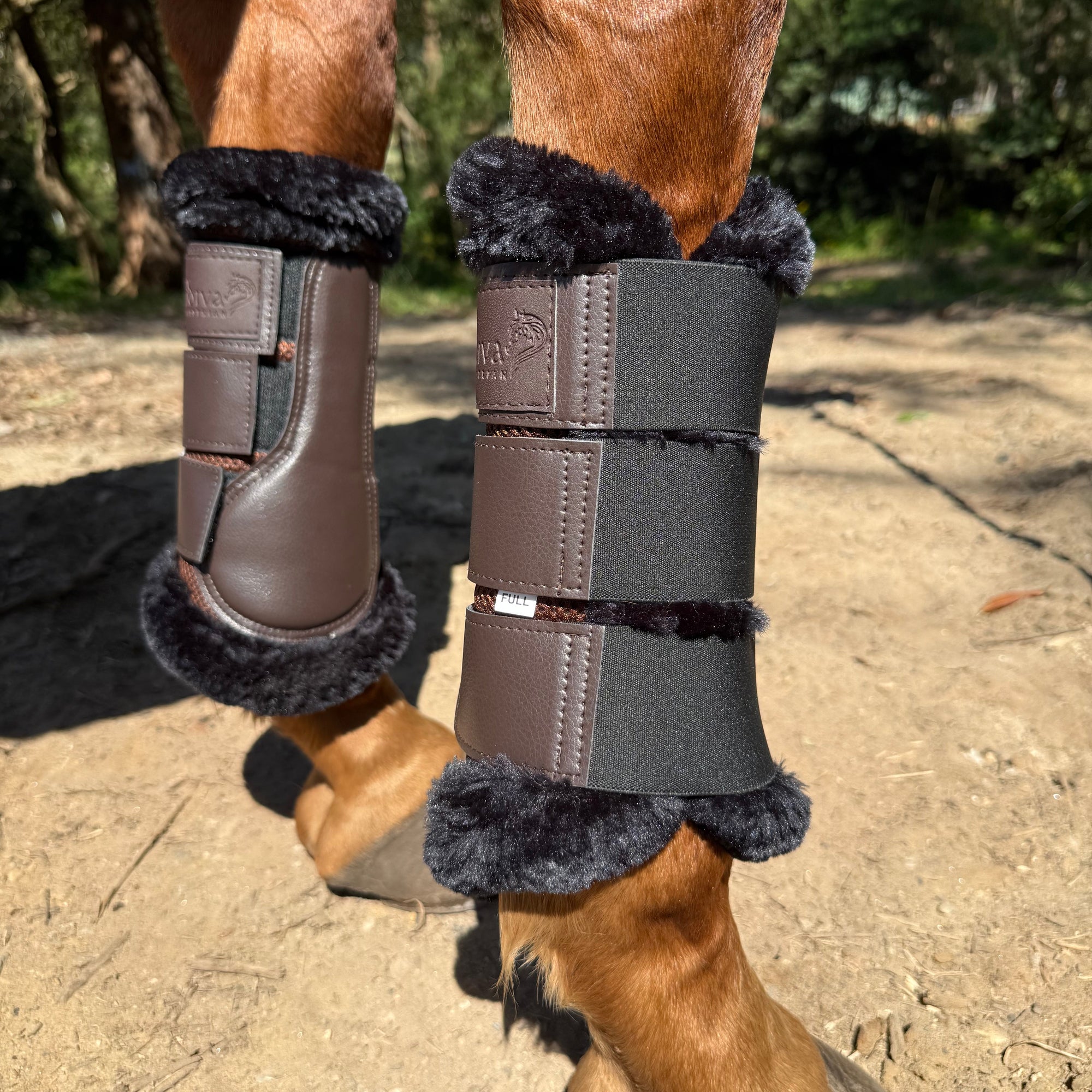 A pair of brown horse brushing boots with fur trim, attached to a horse's front legs, designed to protect the legs during riding activities.